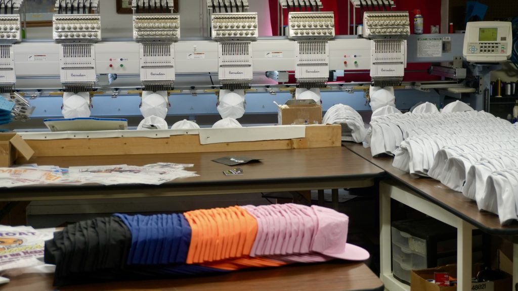 Hats about to be embroidered on a machine at Generation Embroidery. 